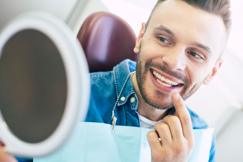 Dental Patient Smiles Confidently After Receiving Dental Implants in Phoenix, Az