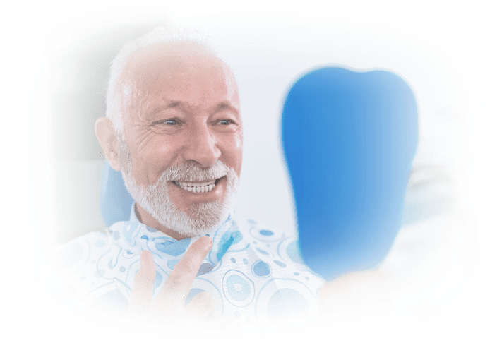 Elderly male patient with white hair smiling at his new dentures in a mirror